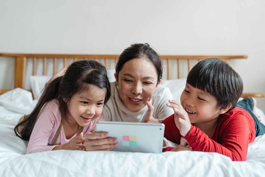 Parent looking at screen usage with kids.